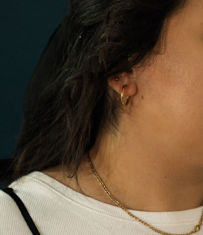 "All Things New" Stainless Steel Gold Oval Huggie Earrings - Black/Gold
